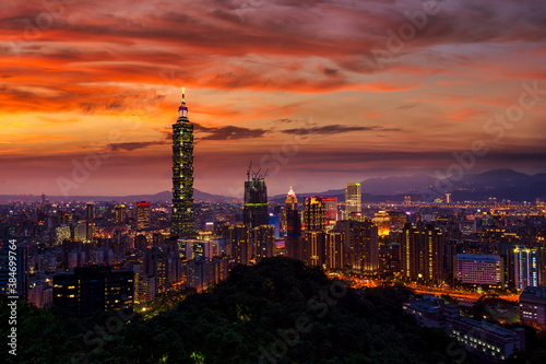 Panoramic aerial view of Downtown Taipei City at dusk, with Taipei 101 Tower in Xinyi Commercial District, Twilight capital city of Taiwan.