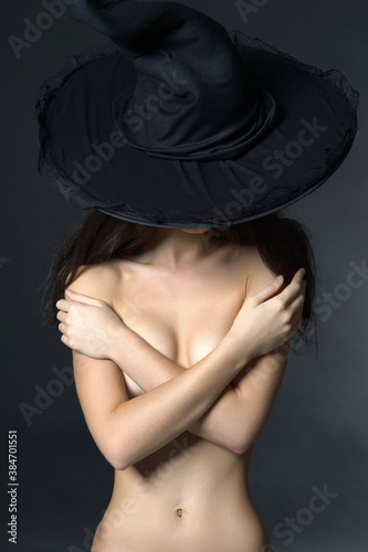 beautiful naked woman in witch hat