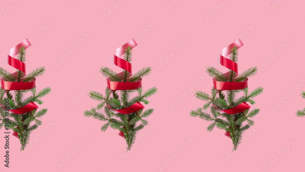 seamless pattern animation with many spruce branches and red curly ribbon. movement in one row direction. Christmas tree and new year concept with copy space on pink pastel background seamless pattern animation with many spruce branches and red curly ribbon. movement in one row direction. Christmas tree and new year concept with copy space on pink pastel background