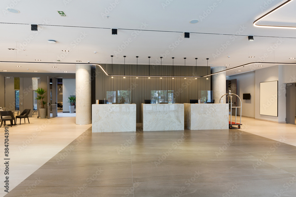 Interior of a hotel lobby with reception desks with transparent