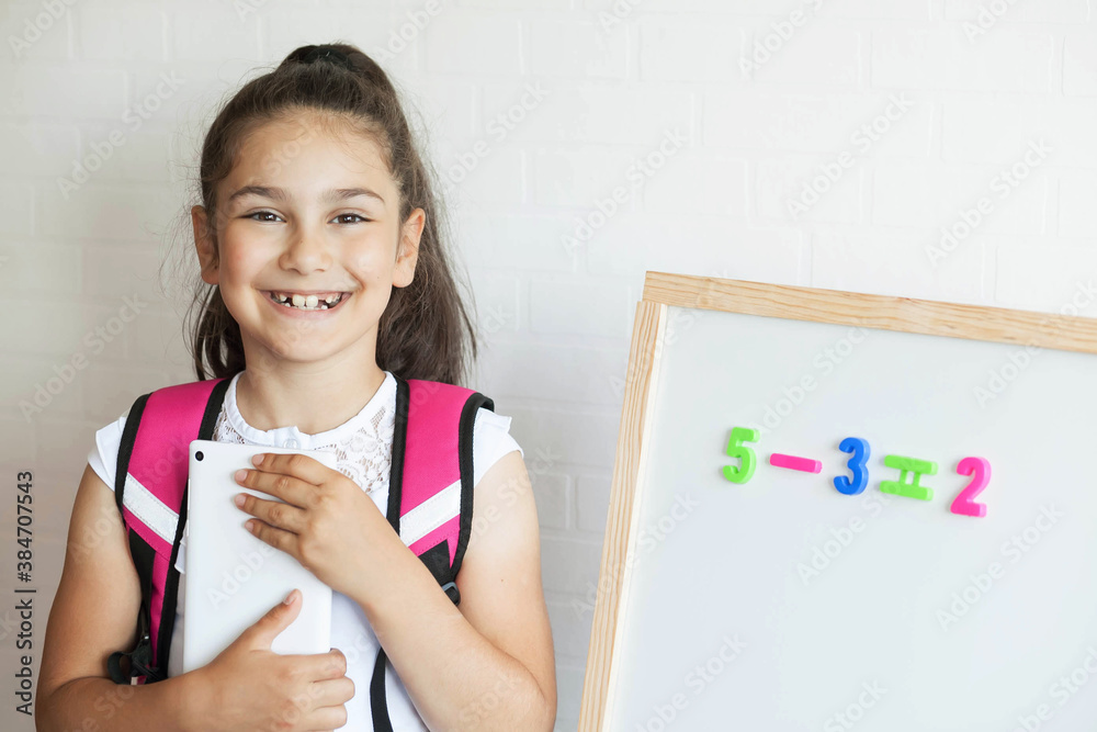 Back to school. Happy cute schoolgirl near the blackboard. Education and school concept. Back to school. Happy cute schoolgirl near the blackboard. Education and school concept.