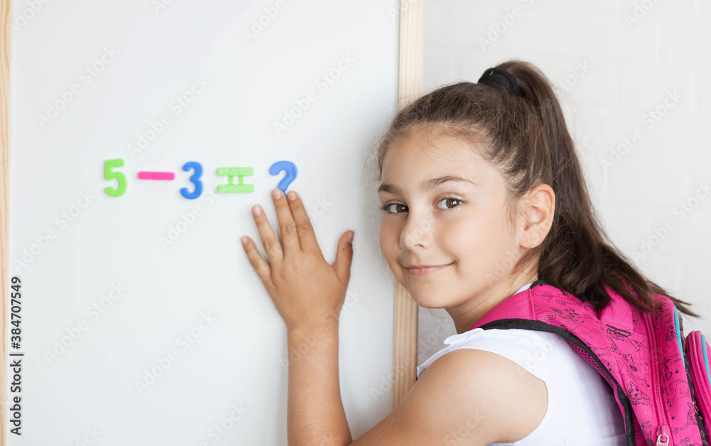 Back to school. Happy cute schoolgirl near the blackboard. Education and school concept. Back to school. Happy cute schoolgirl near the blackboard. Education and school concept.