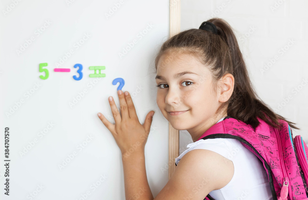 Back to school. Happy cute schoolgirl near the blackboard. Education and school concept. Back to school. Happy cute schoolgirl near the blackboard. Education and school concept.