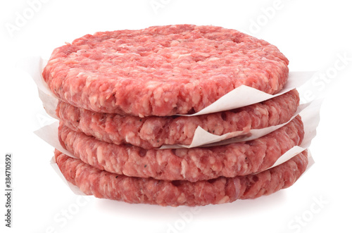 Uncooked raw beef chops burger in stack isolated on white