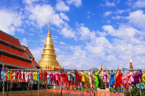 Festival lantern or Colorful lamp hanging on line rope blue sky background , decorations for celebration loy krathong festival in Wat Phra That Hariphunchai woramahawihan lamphun of Thailand photo