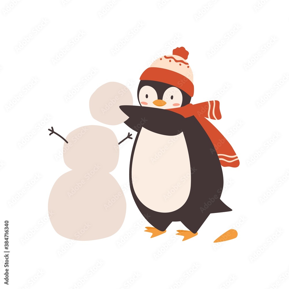 Fototapeta premium Cute baby penguin making snowman, holding snow ball vector flat illustration. Funny arctic bird wearing bobble hat and scarf isolated on white. Polar animal outdoor activity at winter day