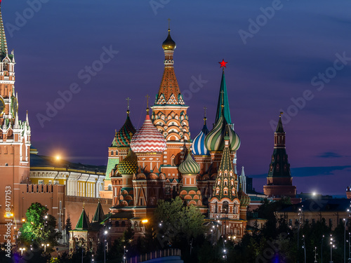Evening photo of St. Basil's Cathedral in Moscow. World landmark against the backdrop of a dark blue sunset sky. Illumination of buildings