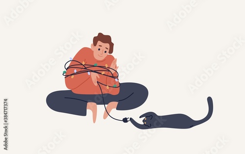 Joyful guy sitting in wrapped Christmas garland playing with cat vector flat illustration. Happy man and pet spend time at Xmas eve isolated. Male domestic animal owner preparing to holiday