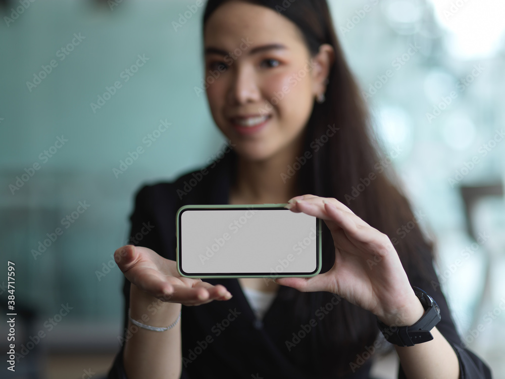 Businesswoman presenting horizontal clipping path smartphone