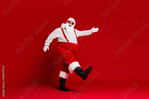 Full length body size view of his he attractive cheerful cheery funny fat white-haired Santa going wearing festal look isolated bright vivid shine vibrant red burgundy maroon color background