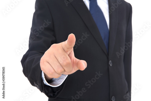 Male in black suit in front of white background stretches out his right hand to make click gesture