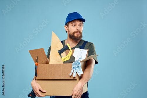 Worker man in uniform box tools construction blue background