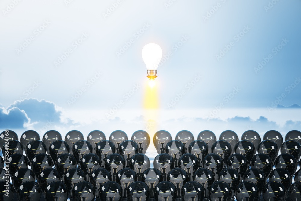 Fototapeta premium Flying lamp rocket on blue sky background.