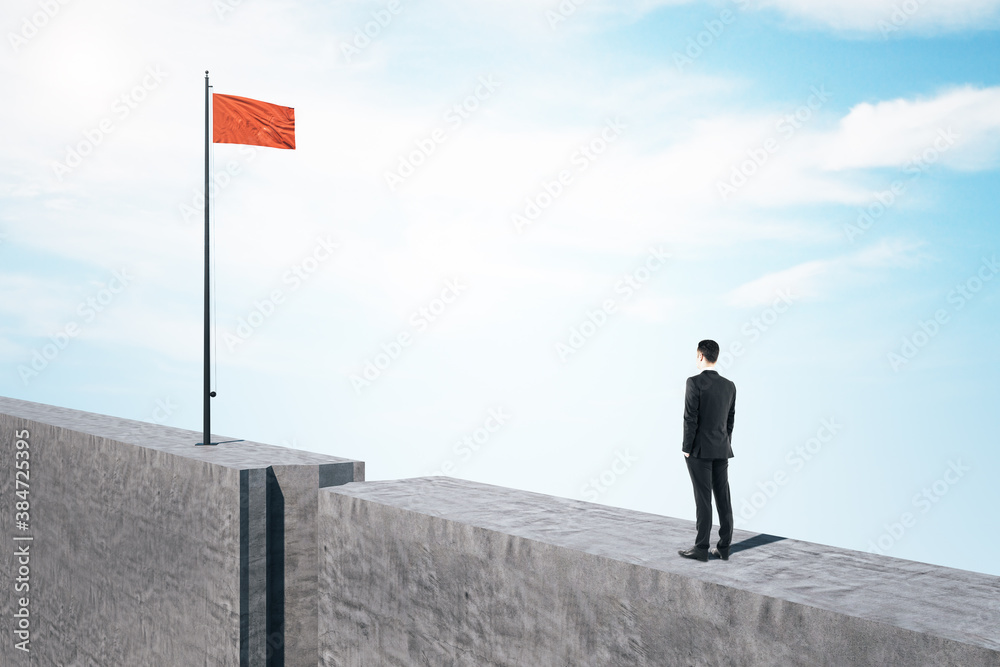Businessman in suit standing on concrete block and looking on flag. Businessman in suit standing on concrete block and looking on flag.