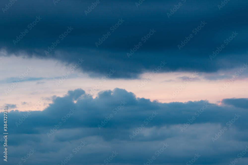 clouds with black clouds at sunset as background