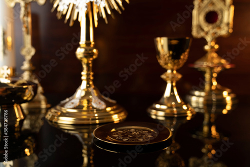 Catholic religion concept. Catholic symbols composition: The Cross, monstrance and golden chalice.