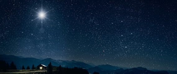 The star shines over the manger of christmas of Jesus Christ.