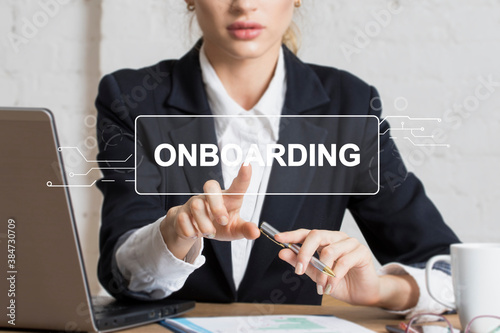 Businessman presses button onboarding process business on virtual panel. photo