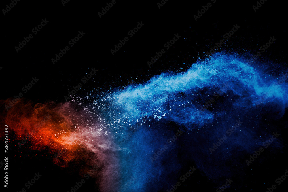 Blue orange color powder explosion on black background.
