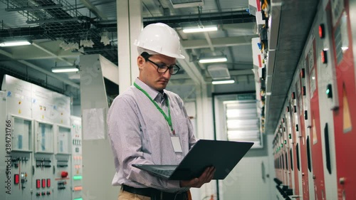 Male specialist is inspecting an electricity facility photo