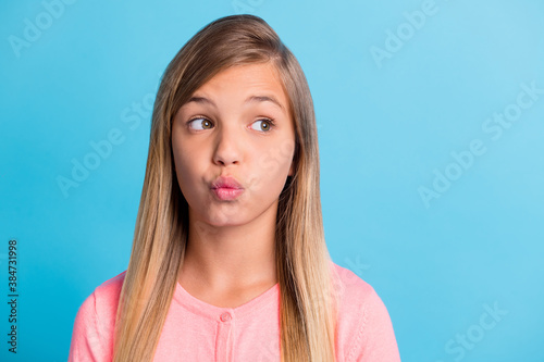 Canvas Print Photo portrait of pouting girl looking at blank space isolated on pastel blue co