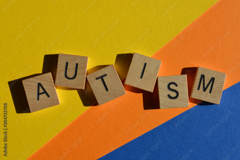 Autism, word in wooden alphabet letters isolated on colourful background Autism, word in wooden alphabet letters isolated on colourful background