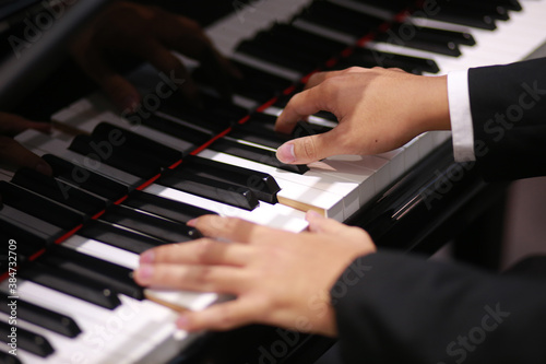 Pianist musician performing live playing piano close up