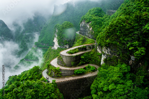 The winding road of Tianmen mountain national park (Zhangjiajie) in clouds mist, Hunan province, China photo