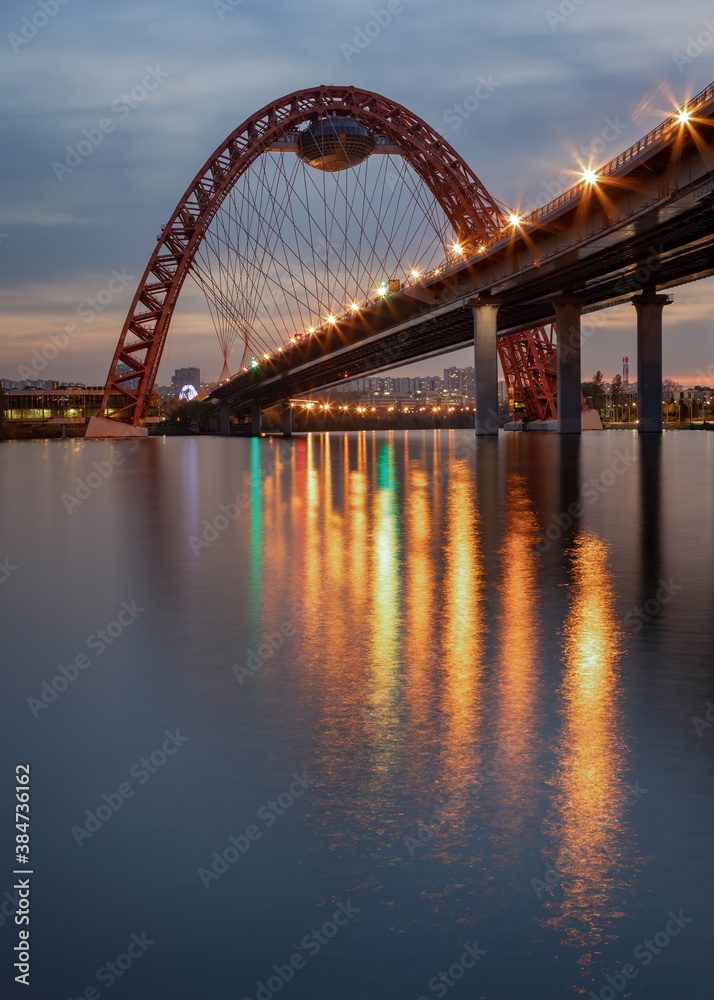 Fototapeta premium Photo of evening lights on a picturesque bridge, reflected in the Moscow river.