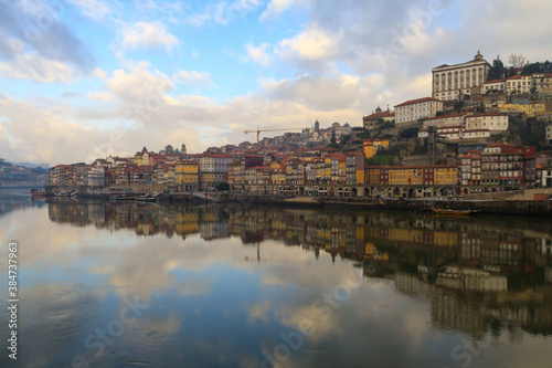 Porto, Portugal panoramic cityscape on the Douro River at sunset. Urban landscape at sunset with traditional boats of Oporto city. Downtown and historic center, travel destination. Oporto landmark. © aroxopt
