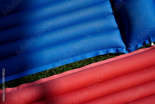 blue and red air mattress in the grass in the garden