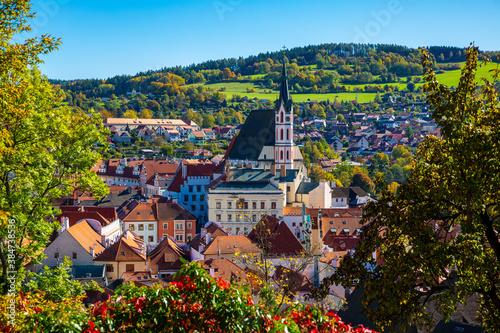 Scenic view of historical centre of Czech town of Cesky Krumlov overlooking gothic bell tower of Cathedral of Saint Vitus on sunny autumn day