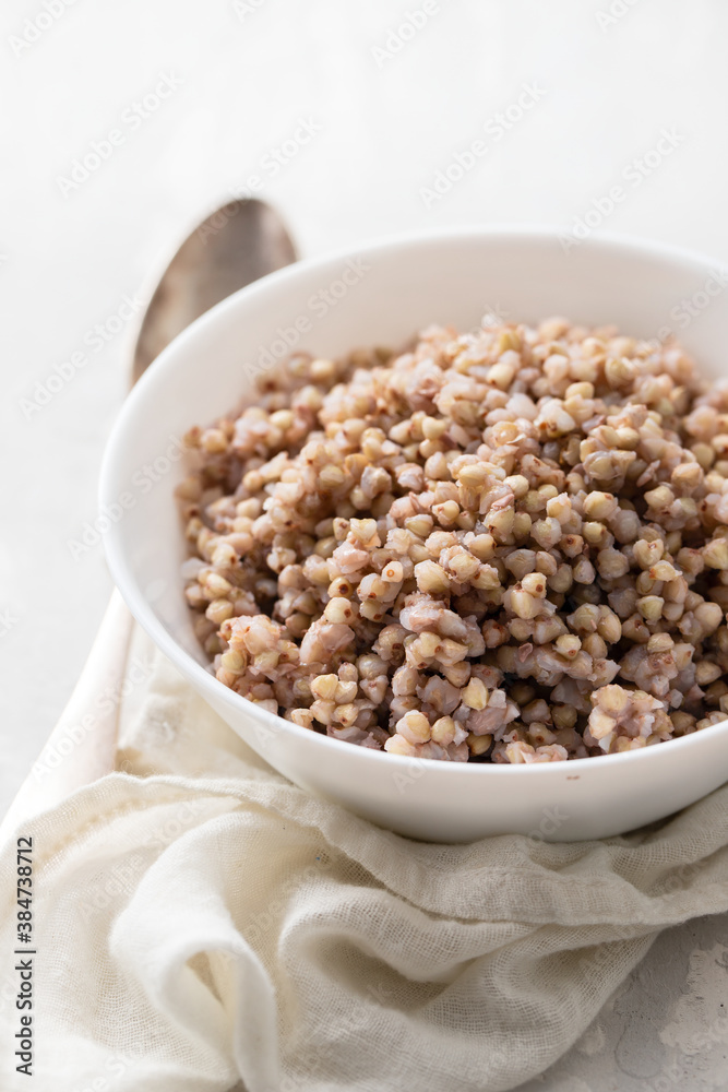 boiled green buckwheat in white bowl on ceramic background boiled green buckwheat in white bowl on ceramic background