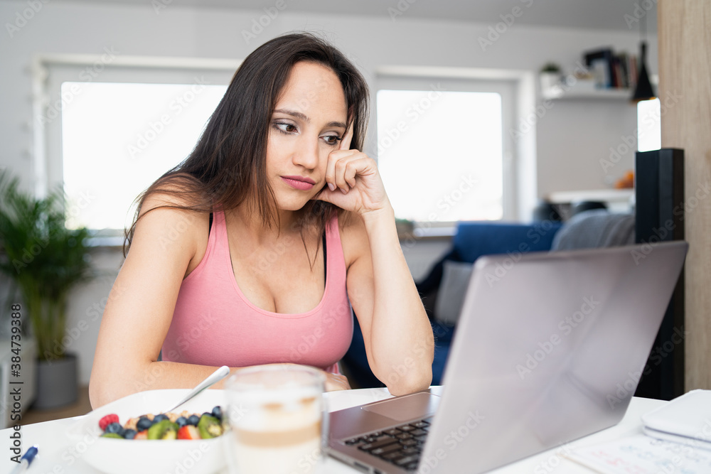 A pregnant woman is worried about the results of a blood test. There is coffee and porridge on the table.