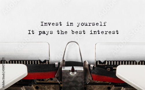 Text Invest in yourself, it pays the best interest typed on retro typewriter photo