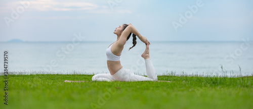 Cuadro en lienzo banner of Vacation of Attractive Asian woman relaxing in yoga king pigeon pose o