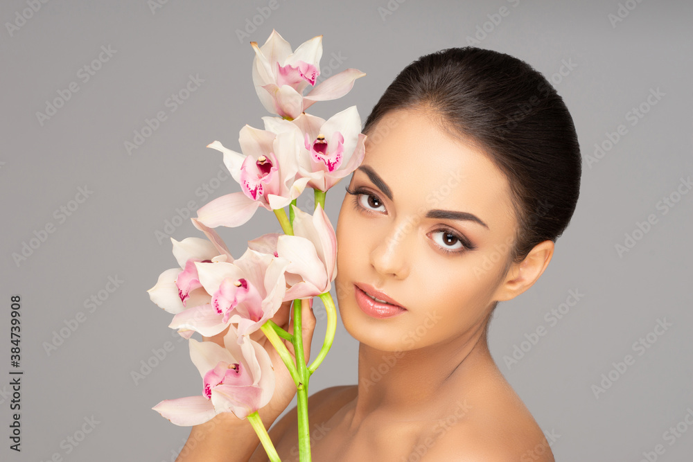 Face of a beautiful brunette girl. Portrait of young and attractive woman over grey background. Face of a beautiful brunette girl. Portrait of young and attractive woman over grey background.