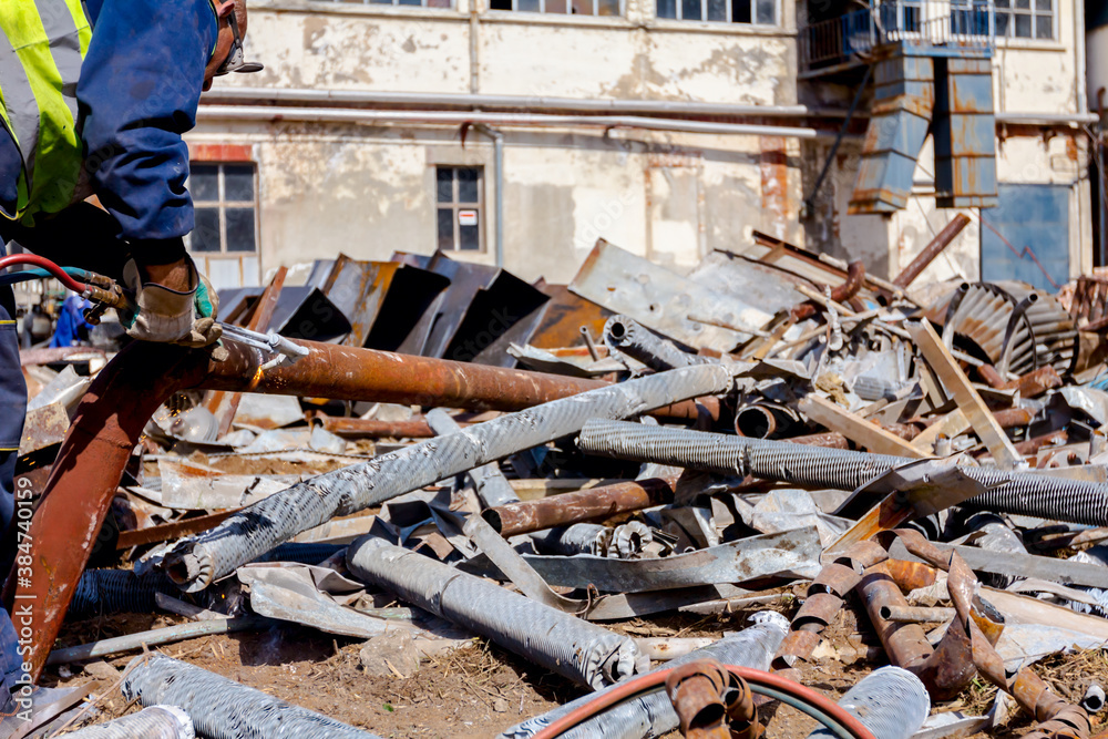 Worker is cutting scrap metal with acetylene torch Stock Photo | Adobe