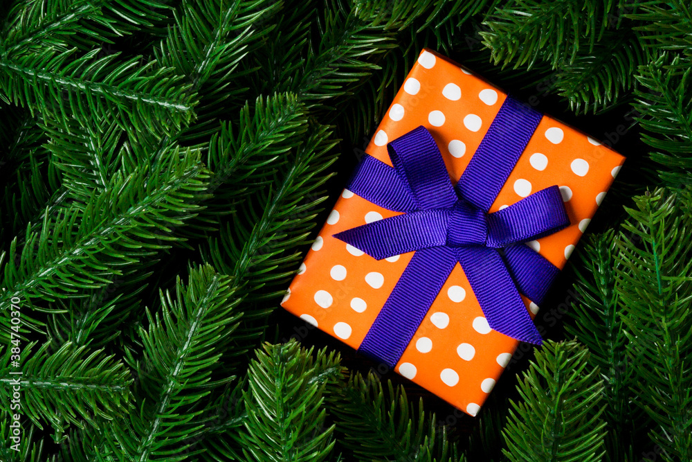 Top view of Christmas gift box on fir tree background. Time for holiday concept with copy space Top view of Christmas gift box on fir tree background. Time for holiday concept with copy space