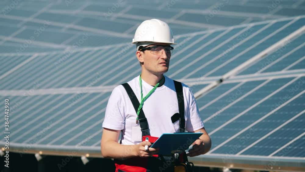 Serviceman is observing a solar power station Serviceman is observing a solar power station