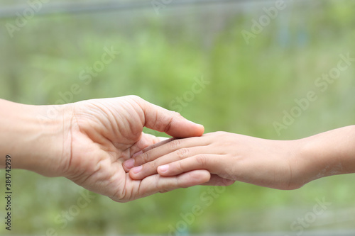 Family helping - Child hand put on  mother hand with love and care © banprik