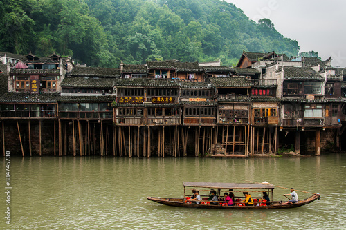 Boat in river take tourists to sightseeing the beautiful Fenghuang ancient town in the morning, Hunan province, China