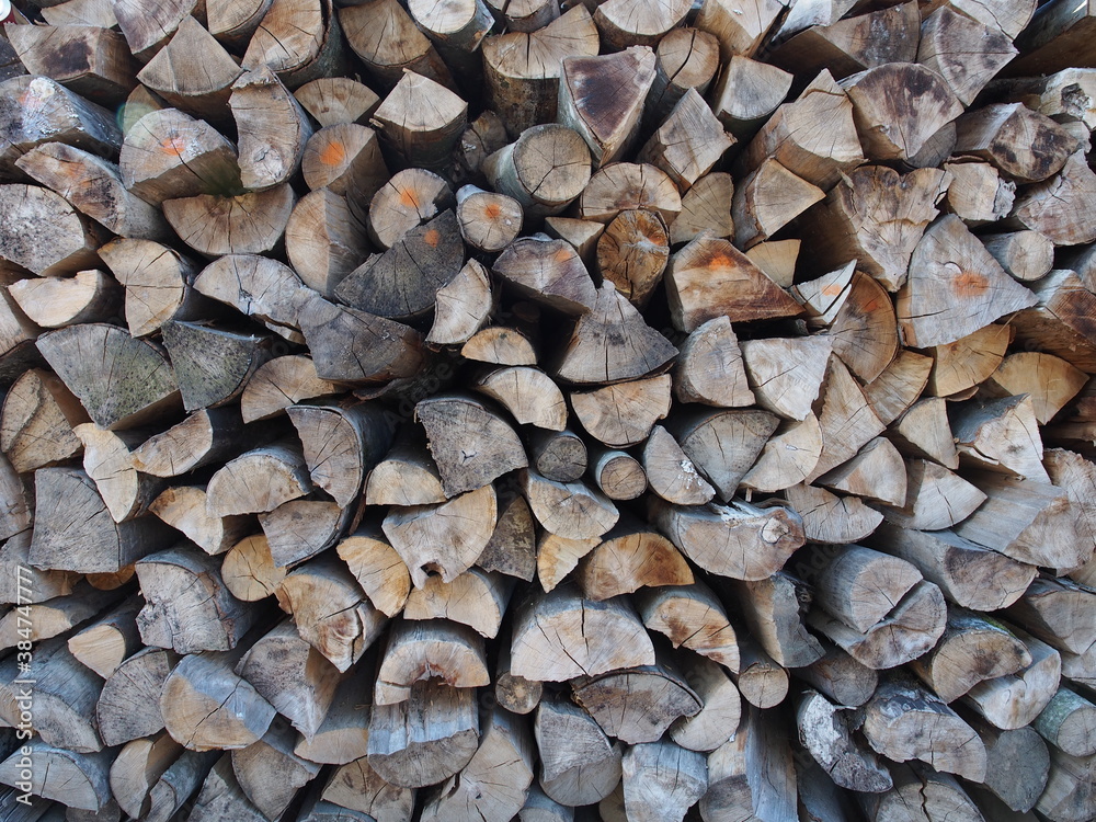Firewood stacked up against a wall , wood for burning beeing stored Firewood stacked up against a wall , wood for burning beeing stored