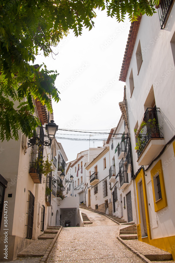 Beautiful typical spanish street in Altea, Costa Blanca, Alicante province, Valencian Community, Spain. Historical center, with white charming houses. 