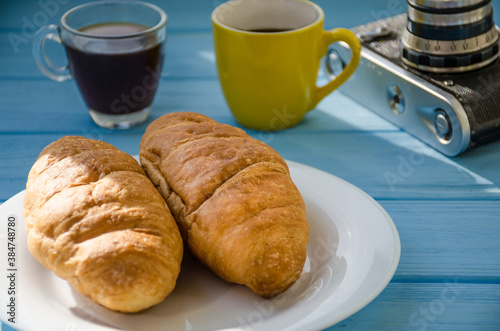 still life of cake with cup of coffee highlighted by sunlight