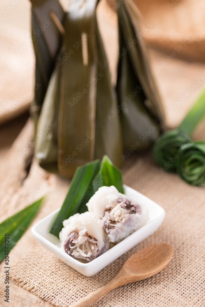 Thai dessert (Khanom sai sai), Steamed rice flour mixed with coconut cream stuffed with sweet sliced coconut wrapped in banana leaf