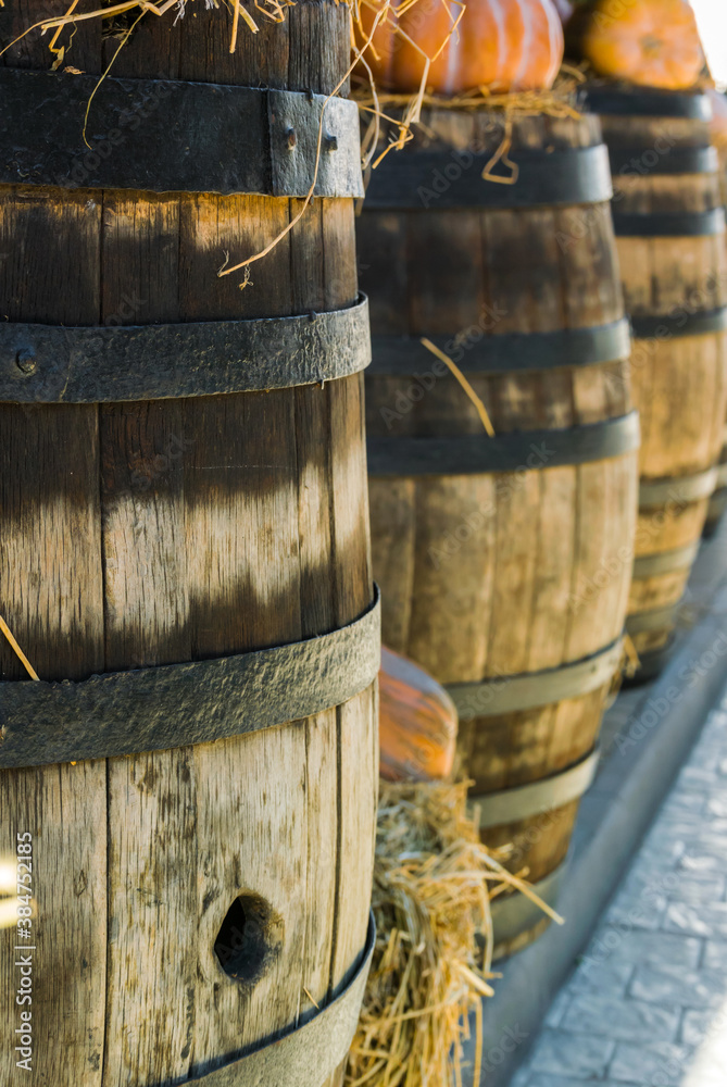 Old wooden barrels with fragments of pumpkins and straw Old wooden barrels with fragments of pumpkins and straw