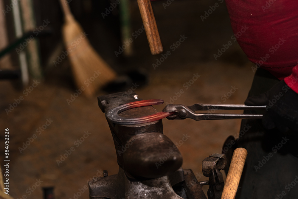 Blacksmith forging a horseshoe Blacksmith forging a horseshoe