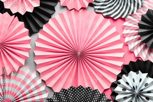 Leinwand Poster Vibrant background with black, pink and white folded paper fans on two tone background