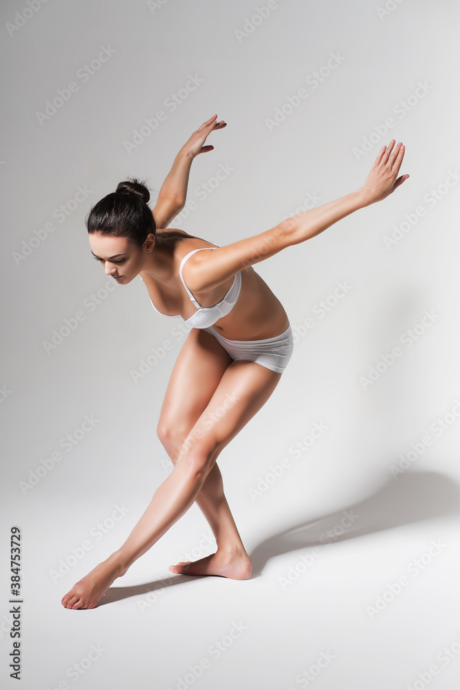 bending ballerina in white studio bending ballerina in white studio